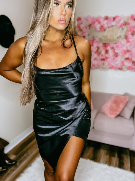 A model showing a black shining dress