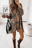 A woman wearing a beige and brown checkered button-down short dress with 3/4 sleeves, carrying a black purse and wearing boots.