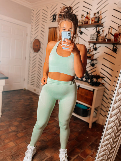 A woman modeling a green sport wear set